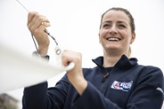 Eilidh McIntyre smiling whilst working on a sailing boat